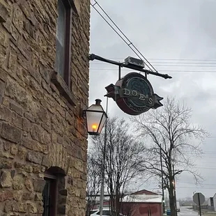 a brick building with a sign on it