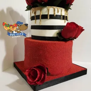 a three tiered cake with red roses