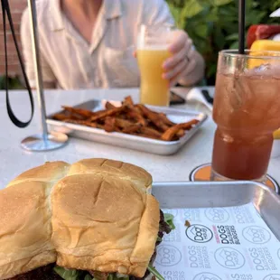 Holy Aioli with arugula, sweet potato fries, cocktail with gin and hibiscus.