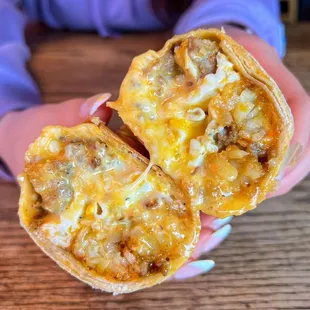 a person holding a burrito
