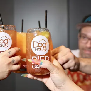 two people toasting with drinks