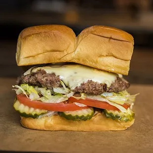 CHEESEBURGER – white american cheese, pickles, lettuce, tomato, onion, secret sauce