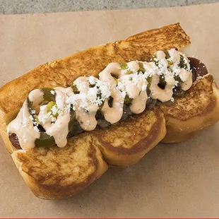 OLD TOWN DOG - smoked bacon wrapped dog, caramelized onions, chipotle aioli, pickled jalape-os, cotija cheese