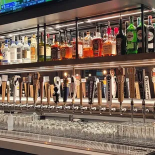 a row of beer taps in a bar