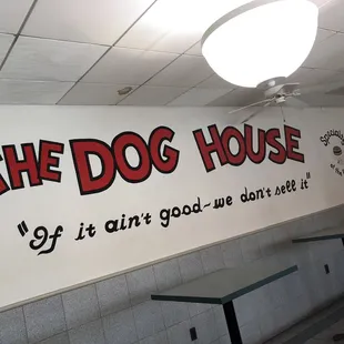 the dog house sign on the wall