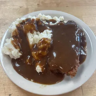 a plate of mashed potatoes and gravy