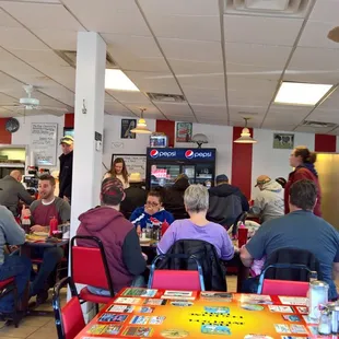 people sitting at tables in a restaurant