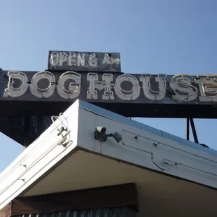 an old neon sign for a dog house