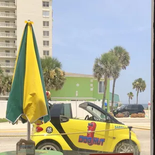 a yellow car parked in front of a building