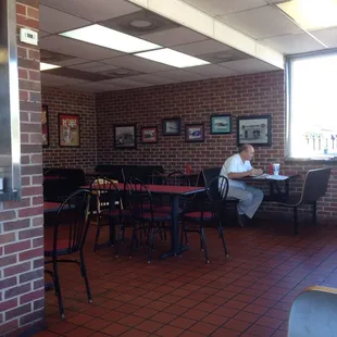 shows a man sitting at a table