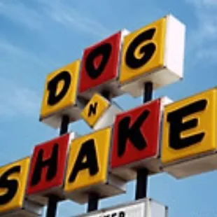 ows a neon sign for a dog - n - shake