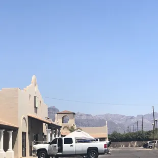Just west of the parking lot and main building.