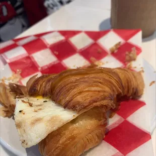 a croissant sandwich on a checkered plate