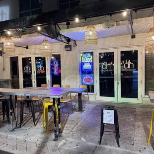 the outside of a restaurant with tables and chairs