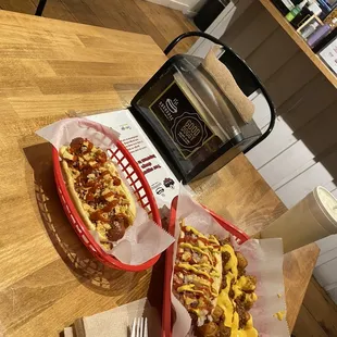 two baskets of hot dogs and a toaster oven