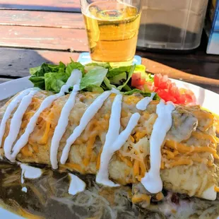 Breakfast burrito packed with crispy tots, eggs, bacon and cheese then smothered with perfectly spicy green chili. Delicious.