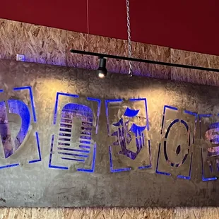 a metal sign hanging on a wall