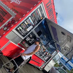 a man standing in front of a food truck