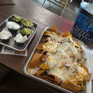 Nachos with sour cream and guac on the side