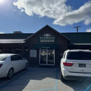 two cars parked in front of the restaurant
