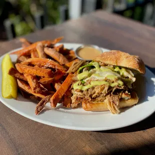 a pulled pork sandwich and sweet potato fries