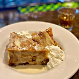 a piece of bread pudding with whipped cream