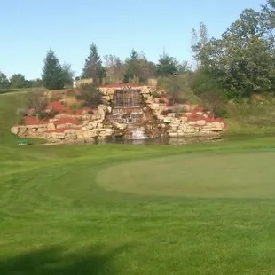 a golf course with a waterfall
