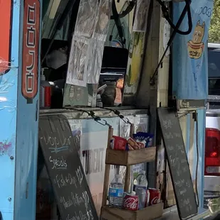a dog sitting in the back of a food truck