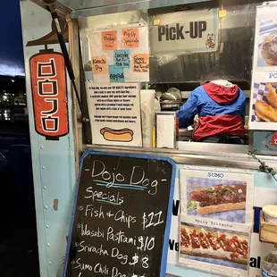 a sign in front of a food truck