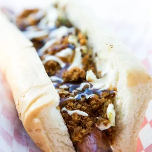 WUSHU DOG Pork sung and flash-grilled cabbage drizzled with a sweet and savory katsu sauce, topped with Japanese mayo