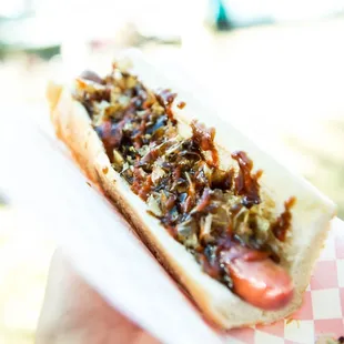 KENDO DOG Sprinkled with bonito fish flakes and flash-grilled cabbage drizzled with a rich soy paste, topped with wasabi mayo