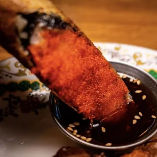 Crispy Salmon Roll. Surprisingly tasty. Salmon inside roll. Tobiko on the exterior.