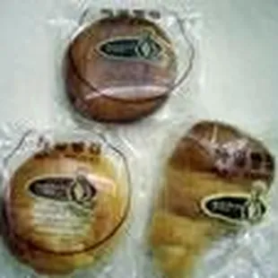 three donuts wrapped in plastic