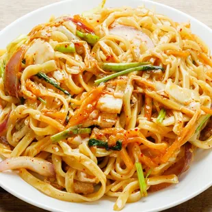 a plate of noodles with meat and vegetables