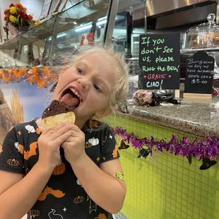 a little girl eating a donut