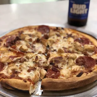 Custom pizza with chicken, bacon, pepperoni, extra cheese. Delicious!