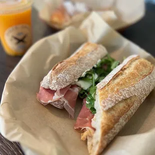 Baguette sandwich with prosciutto di parma, cream cheese, fig spread, arugula, and mozzarella