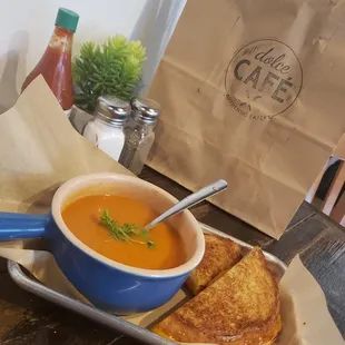 a bowl of soup and a grilled cheese sandwich