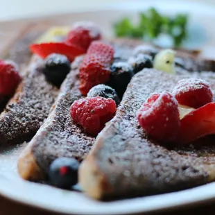 a plate of french toast with berries