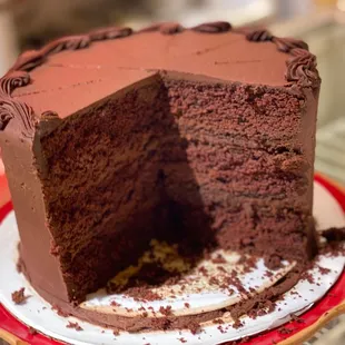 a chocolate cake with a slice taken out of it