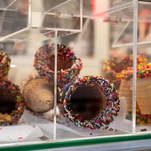a display of donuts with sprinkles