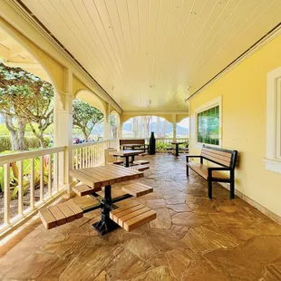 Wrap around porch with tables.