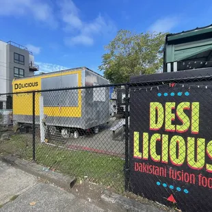 a sign in front of a chain link fence