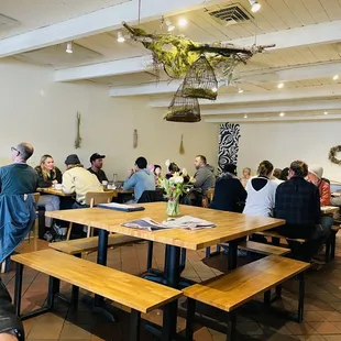 people sitting at tables in a restaurant