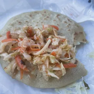 Spicy curtido on my hot and cheesy pupusa! Yummmmmmm!!