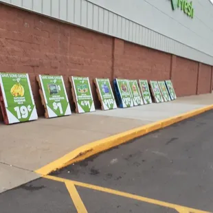 a row of signs in front of a store