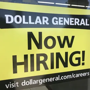 now hiring sign in store window