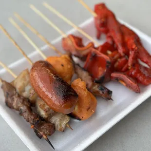 a plate of skewered food
