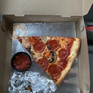 a slice of pizza in a box