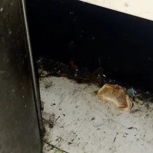 This orange slice has been on the floor for over a month.  This store is filthy.